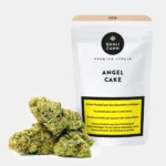 Cannabis CBD Blüten in hellgrünen Tönen mit orangefarbenen Härchen vor weißer Verpackung mit der Aufschrift ‚Angel Cake